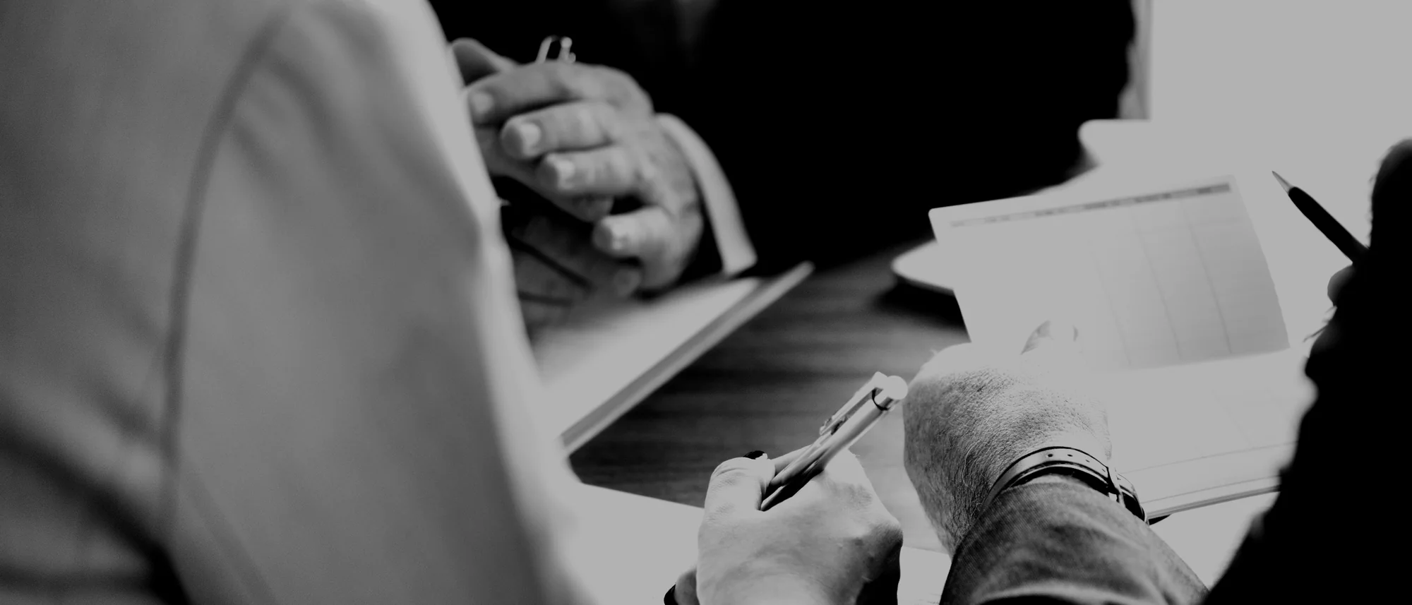 Two people working through documents across a table